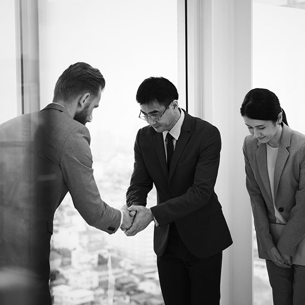 An international business meeting between Japanese professionals and an Australian man.